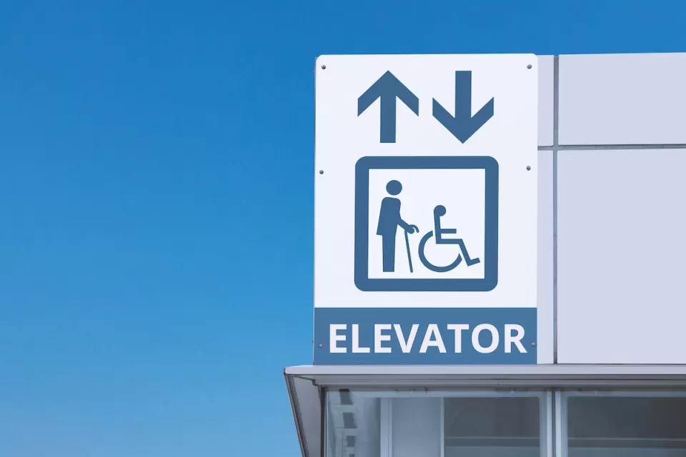 Close-up of subway station elevator sign.